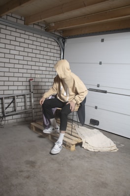 The unnamed hoodie draped simply over a neutral gray chair.