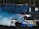 Two sports cars are drifting on a track, creating a large amount of smoke. A crowd of spectators watches from the background, while the cars maneuver through the controlled skid. The visible decals and vibrant colors on the cars add a dynamic element to the scene.
