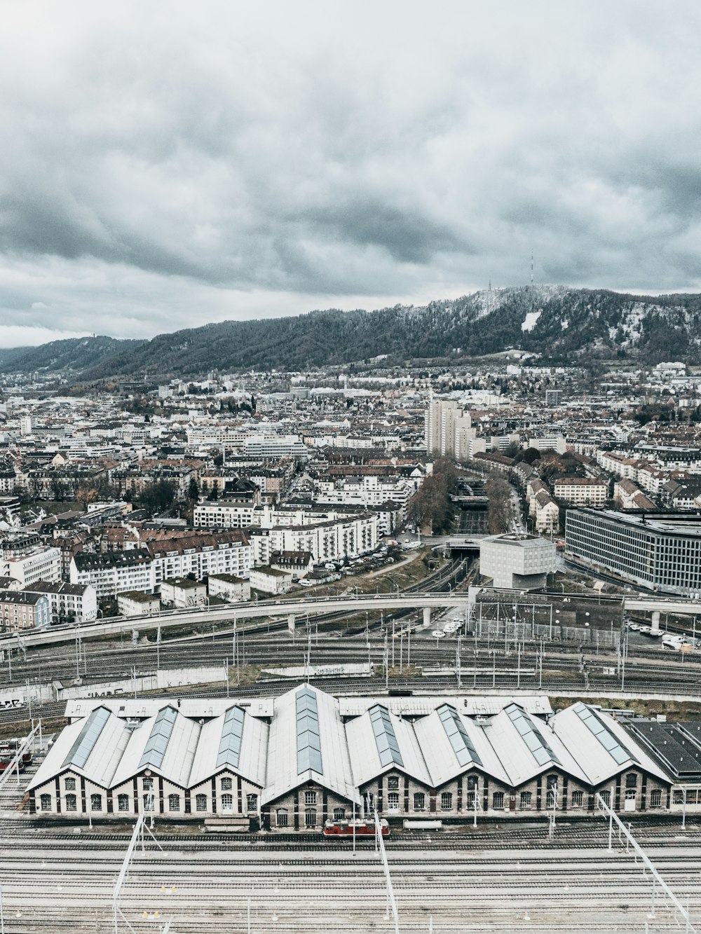 an aerial view of a train station in a city