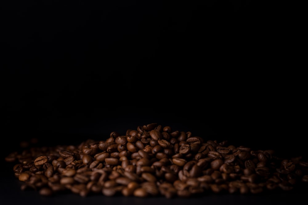 a pile of coffee beans sitting on top of a table