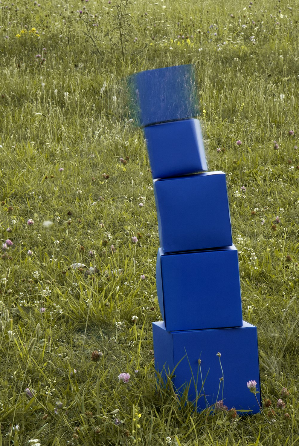 a person sitting on top of a grass covered field