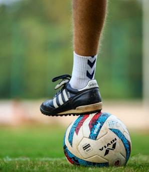 a close up of a person's feet on a soccer ball