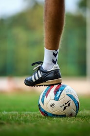 a close up of a person's feet on a soccer ball