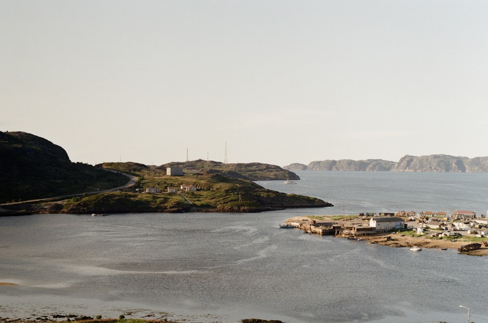 a body of water surrounded by hills and houses