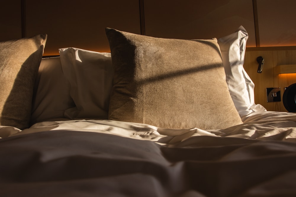 a close up of two pillows on a bed