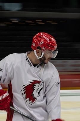a hockey player with a red helmet and goggles