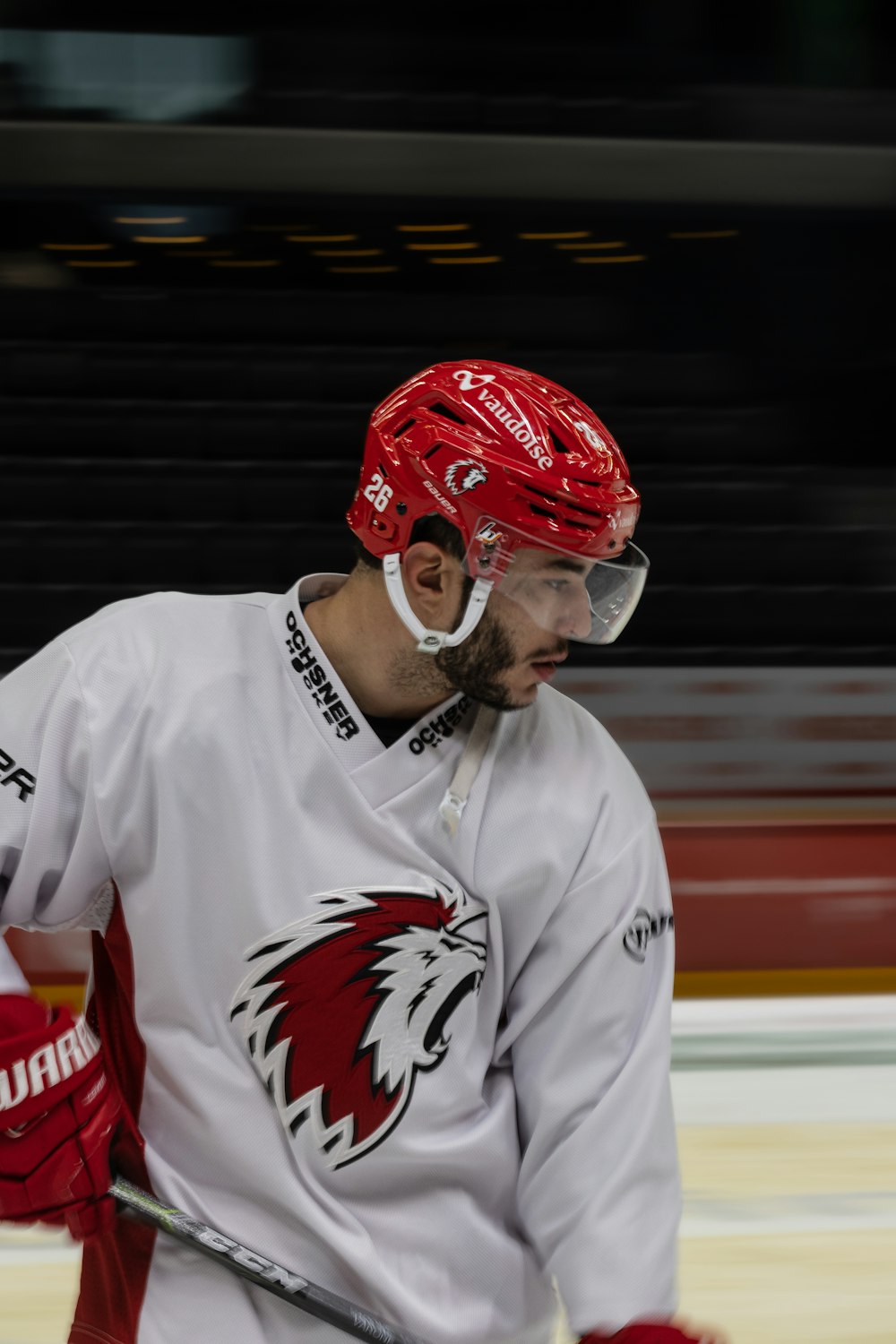 a hockey player with a red helmet and goggles