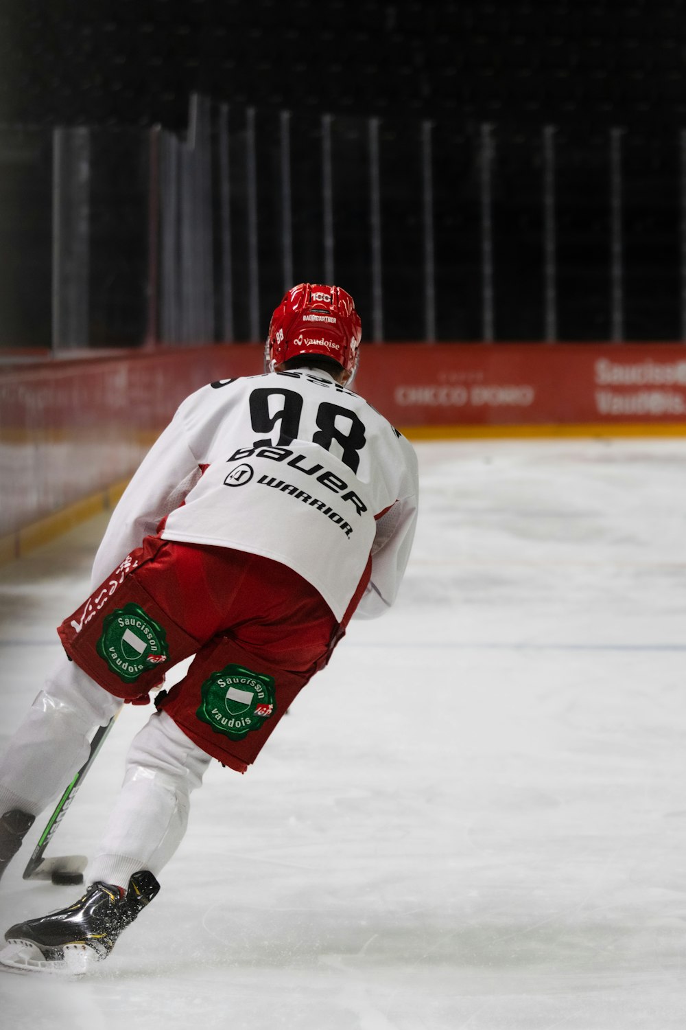 a man in white and red uniform skating on ice