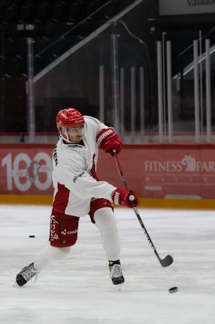A focused young hockey player practicing stickhandling drills on the ice.