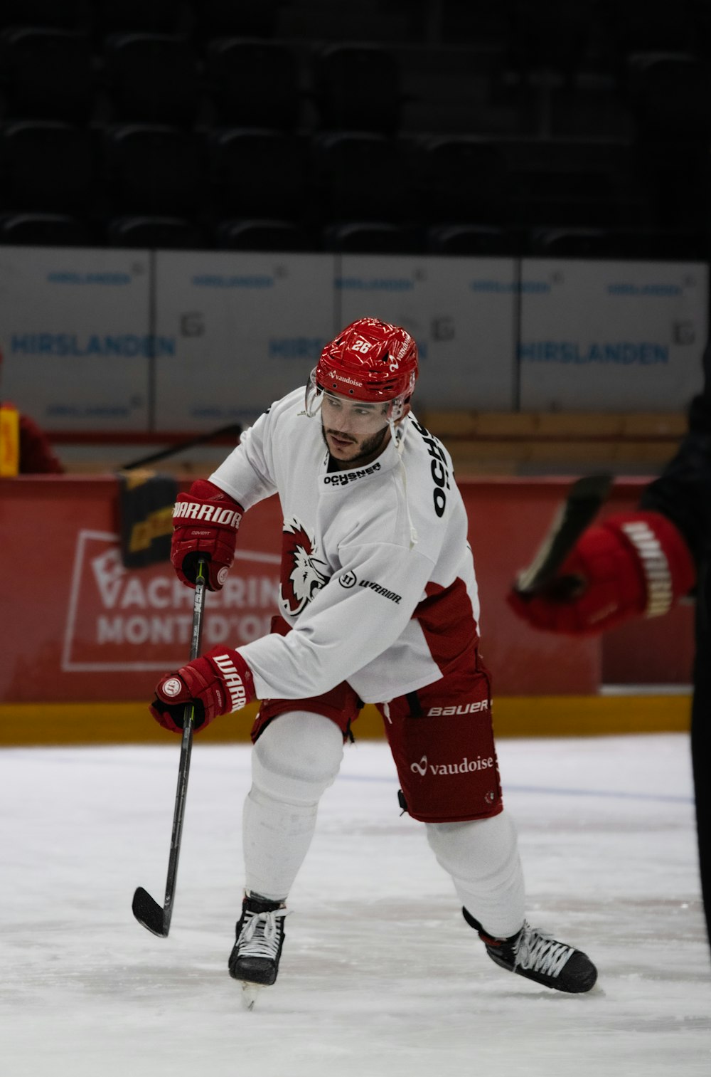 a man in a red and white uniform playing ice hockey