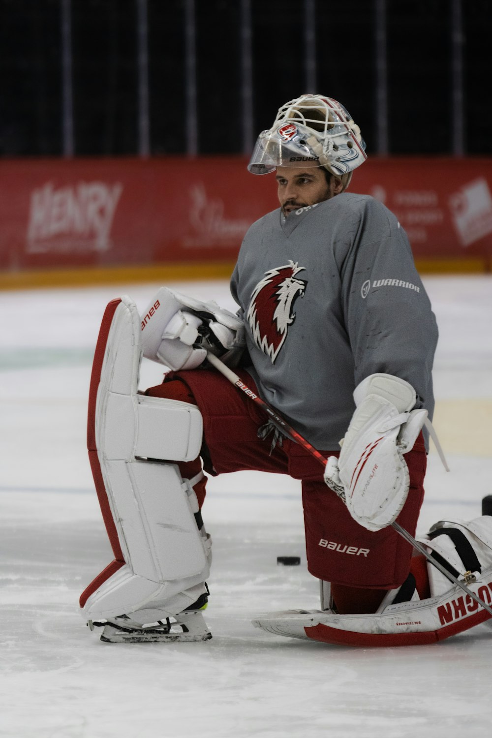 a hockey goalie sitting on the ice