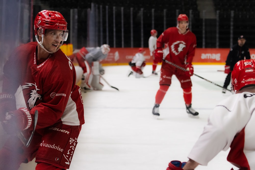 a group of young men playing a game of ice hockey