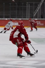 a group of people playing a game of ice hockey