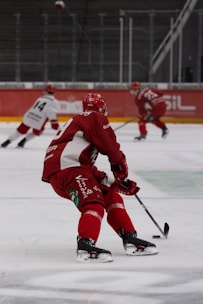 a group of people playing a game of ice hockey