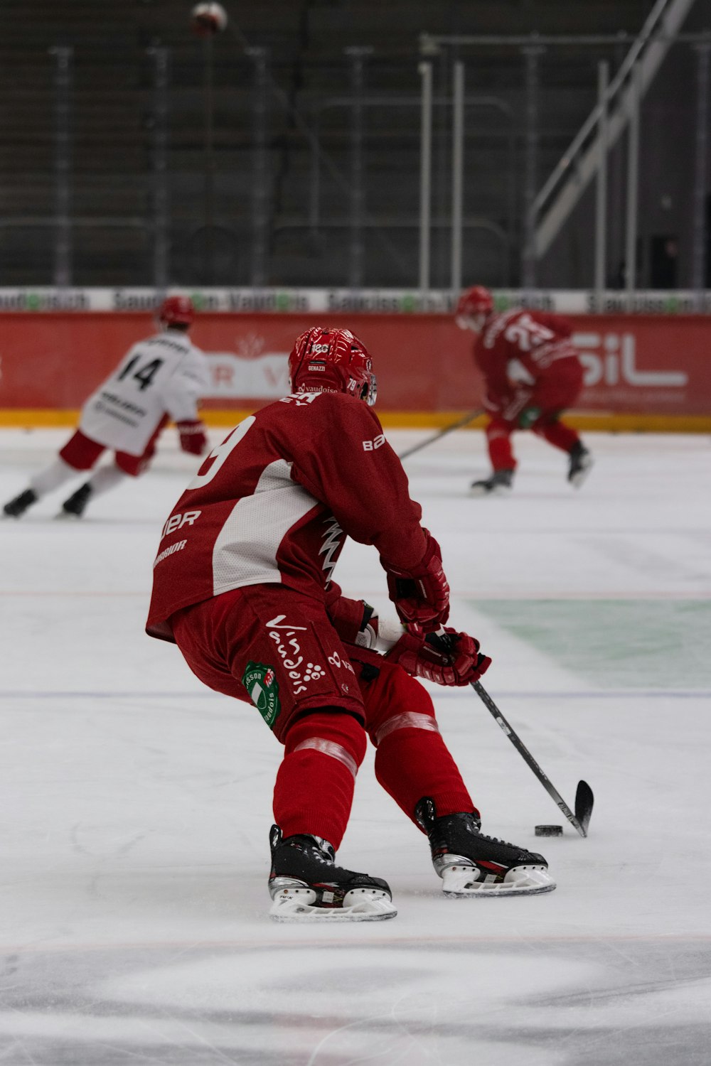 a group of people playing a game of ice hockey