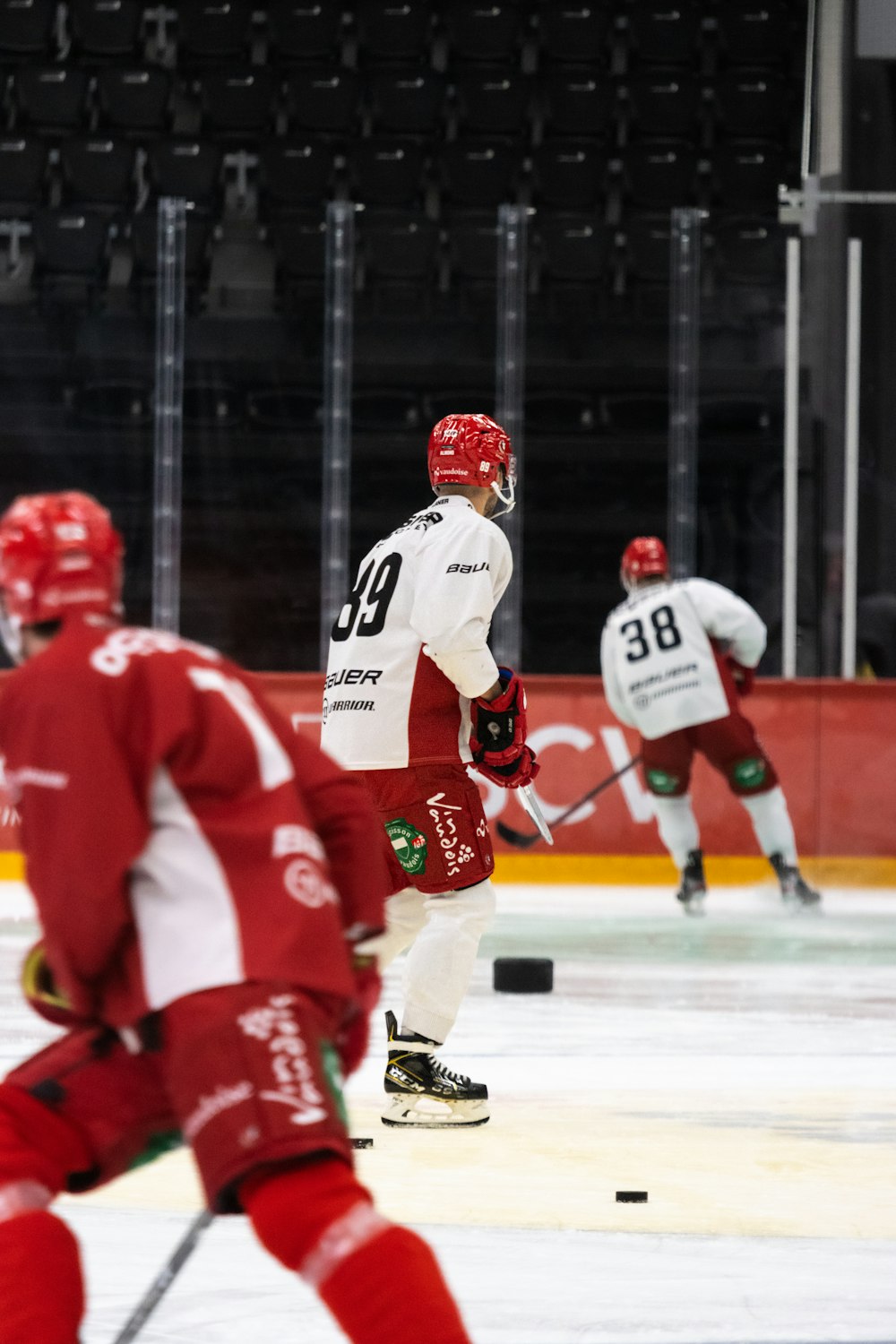 a group of people playing a game of ice hockey