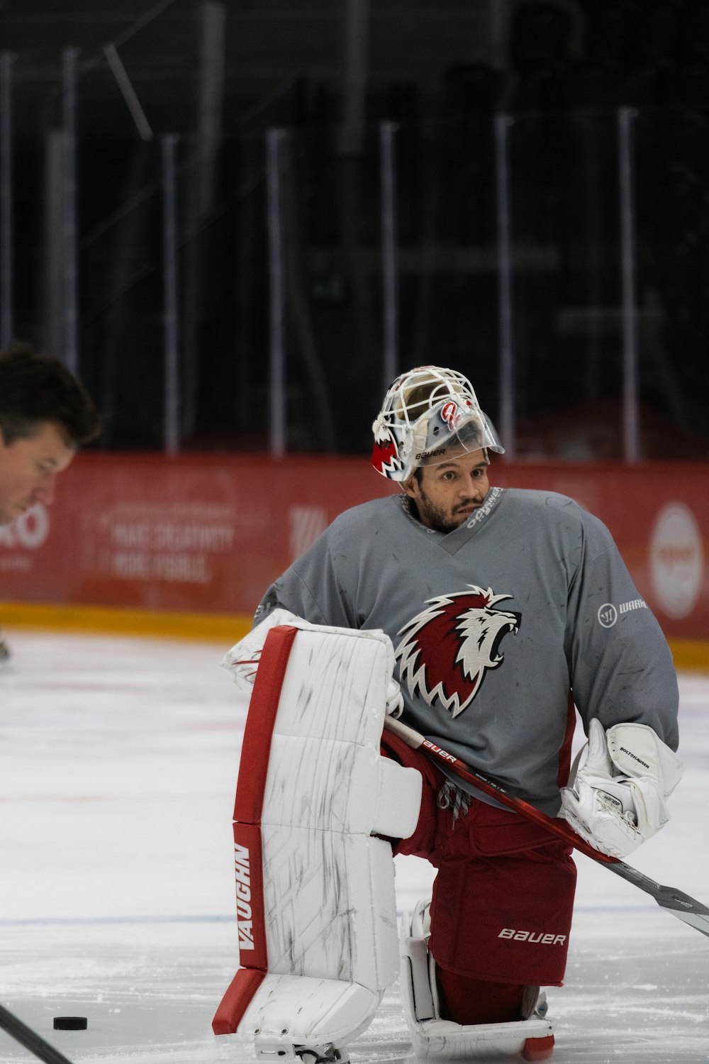 a hockey player holding a hockey goalie's net