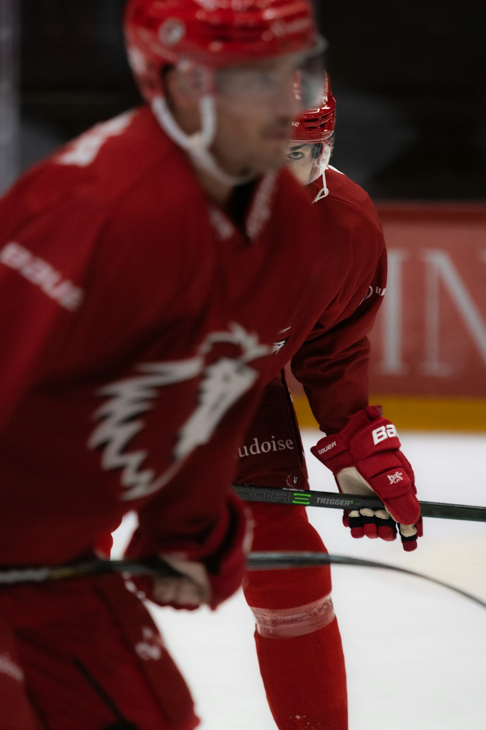 a man in a red uniform is playing hockey
