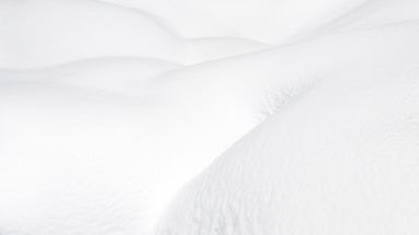 a snow covered bed with white sheets and pillows