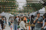 A bustling street market with multiple shops using premium 4-meter flags to stand out among competitors.