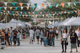 A community event where sustainable brands connect with customers in an outdoor market.