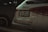 The rear view of a white Mercedes-Benz A35 AMG parked next to another vehicle. The vehicle's license plate is visible, and the Mercedes-Benz logo is prominently displayed. The taillights are sleek and modern, matching the car's sporty aesthetic.