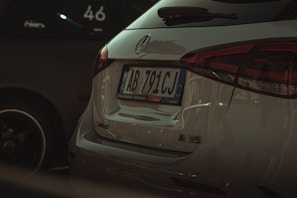 Front view of a sleek red 2025 Mercedes Classe C AMG parked on a quiet street in Yvelines.