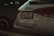 The rear view of a white Mercedes-Benz A35 AMG parked next to another vehicle. The vehicle's license plate is visible, and the Mercedes-Benz logo is prominently displayed. The taillights are sleek and modern, matching the car's sporty aesthetic.