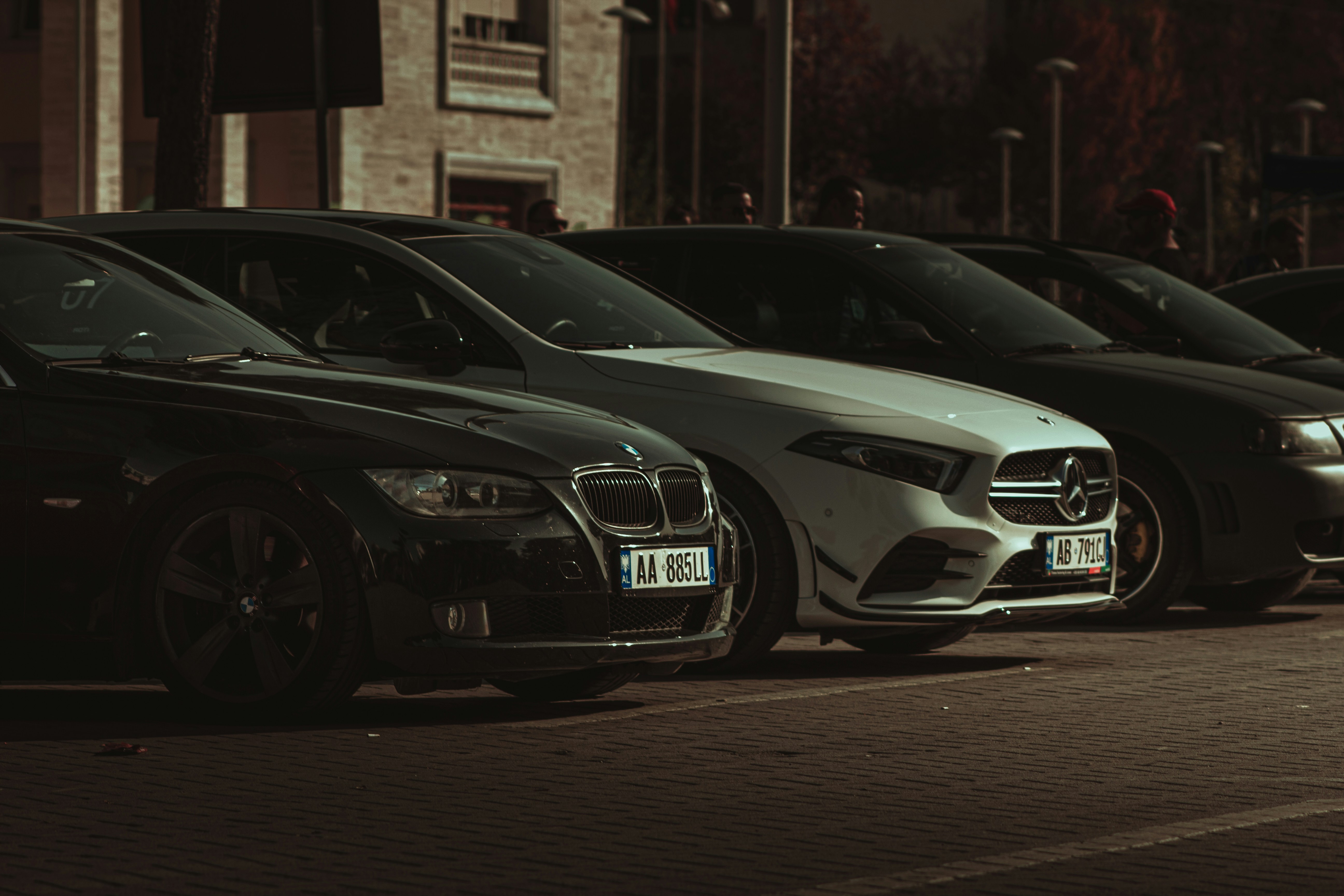 a row of parked cars sitting on the side of a road