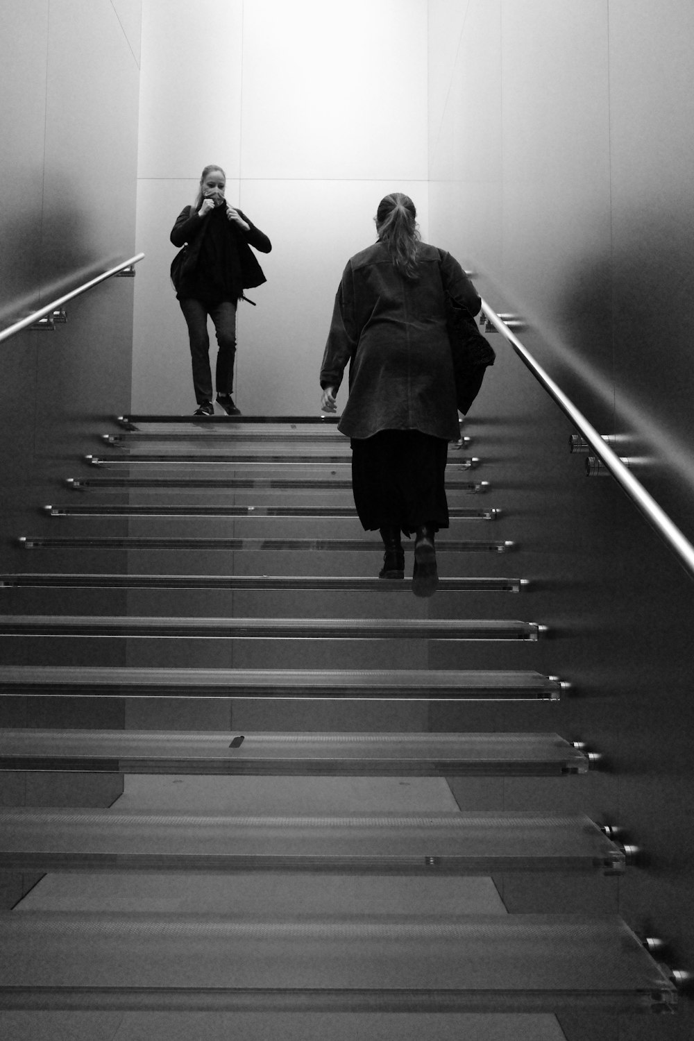 two women walking up a flight of stairs