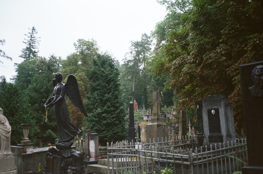 a cemetery with a statue of an angel