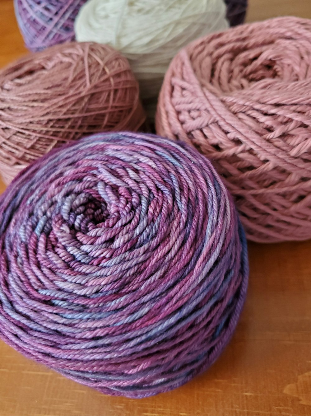 three skeins of yarn sitting on a table