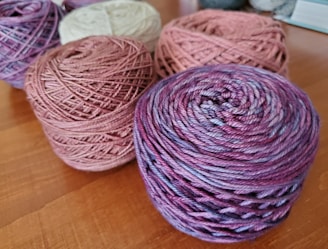 three balls of yarn sitting on a table