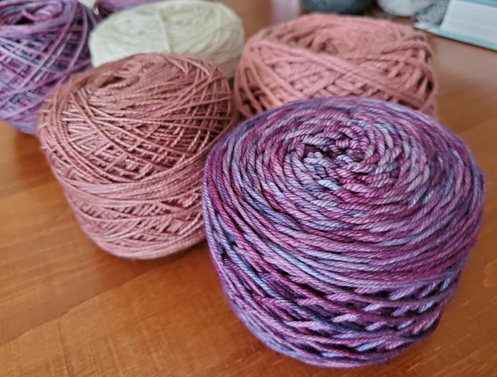 three balls of yarn sitting on a table