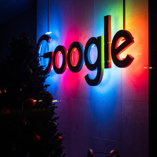 the google logo is lit up at night