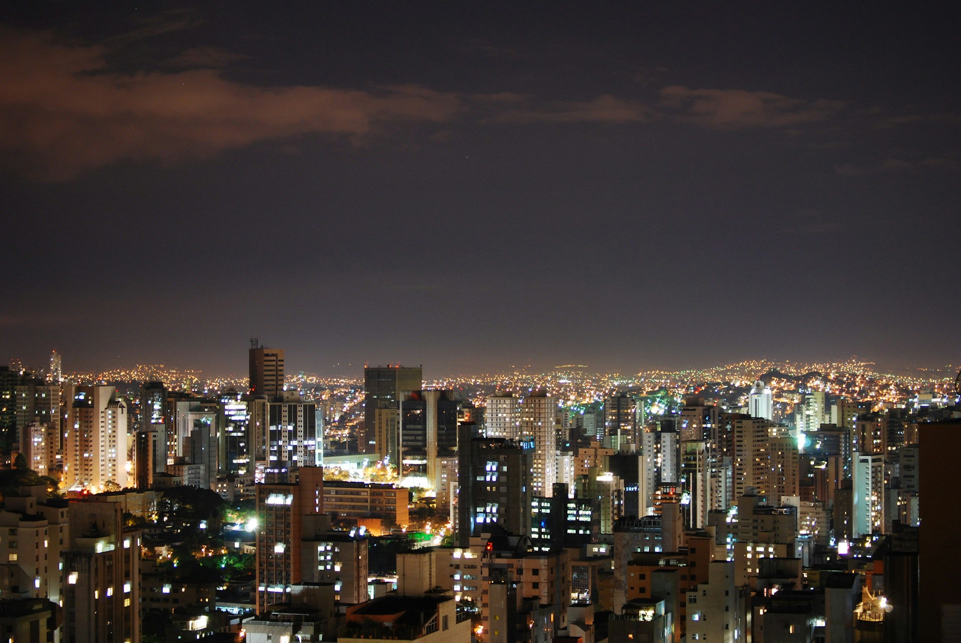 a city at night with a lot of tall buildings