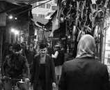 Black and white photo capturing the lively street scene of a bustling African market.