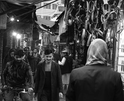 Black and white photo capturing the lively street scene of a bustling African market.