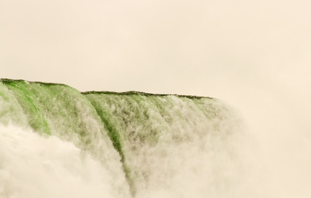 a man standing on top of a waterfall