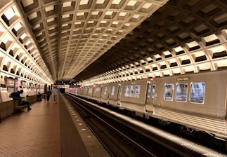 A serene metro station with people waiting for trains in a clean environment.
