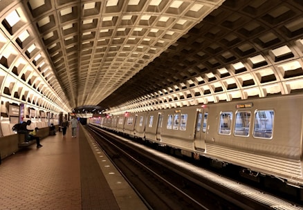 A serene metro station with people waiting for trains in a clean environment.
