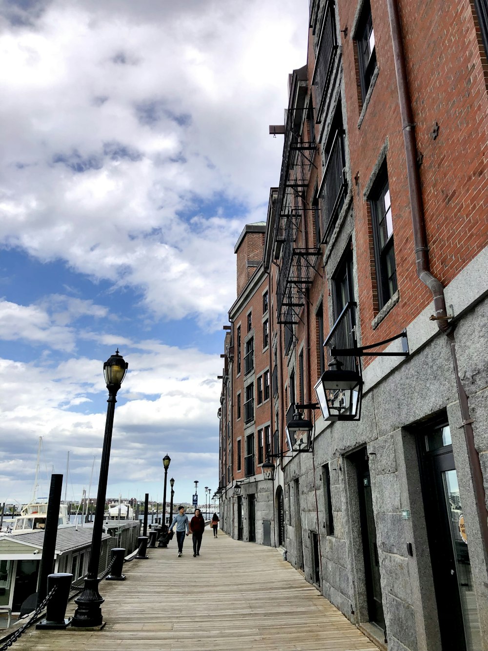 a person walking down a sidewalk next to a building