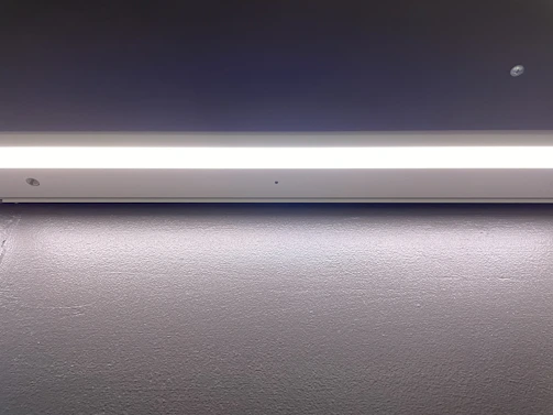 A sleek modern LED panel casting soft, even light in a minimalist living room.