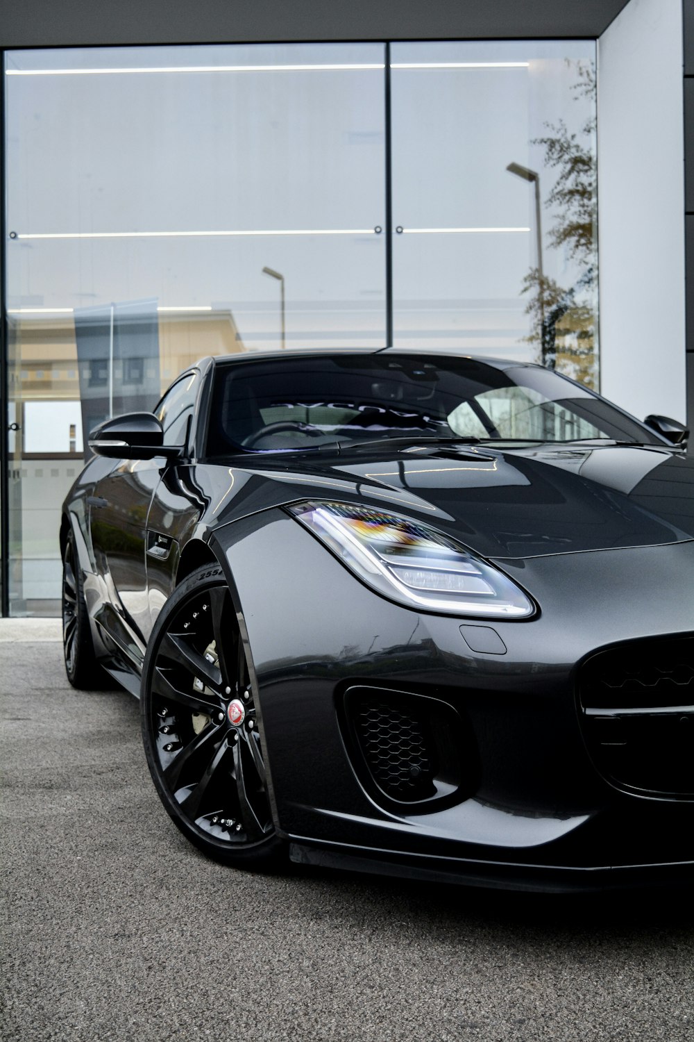 a black sports car parked in front of a building