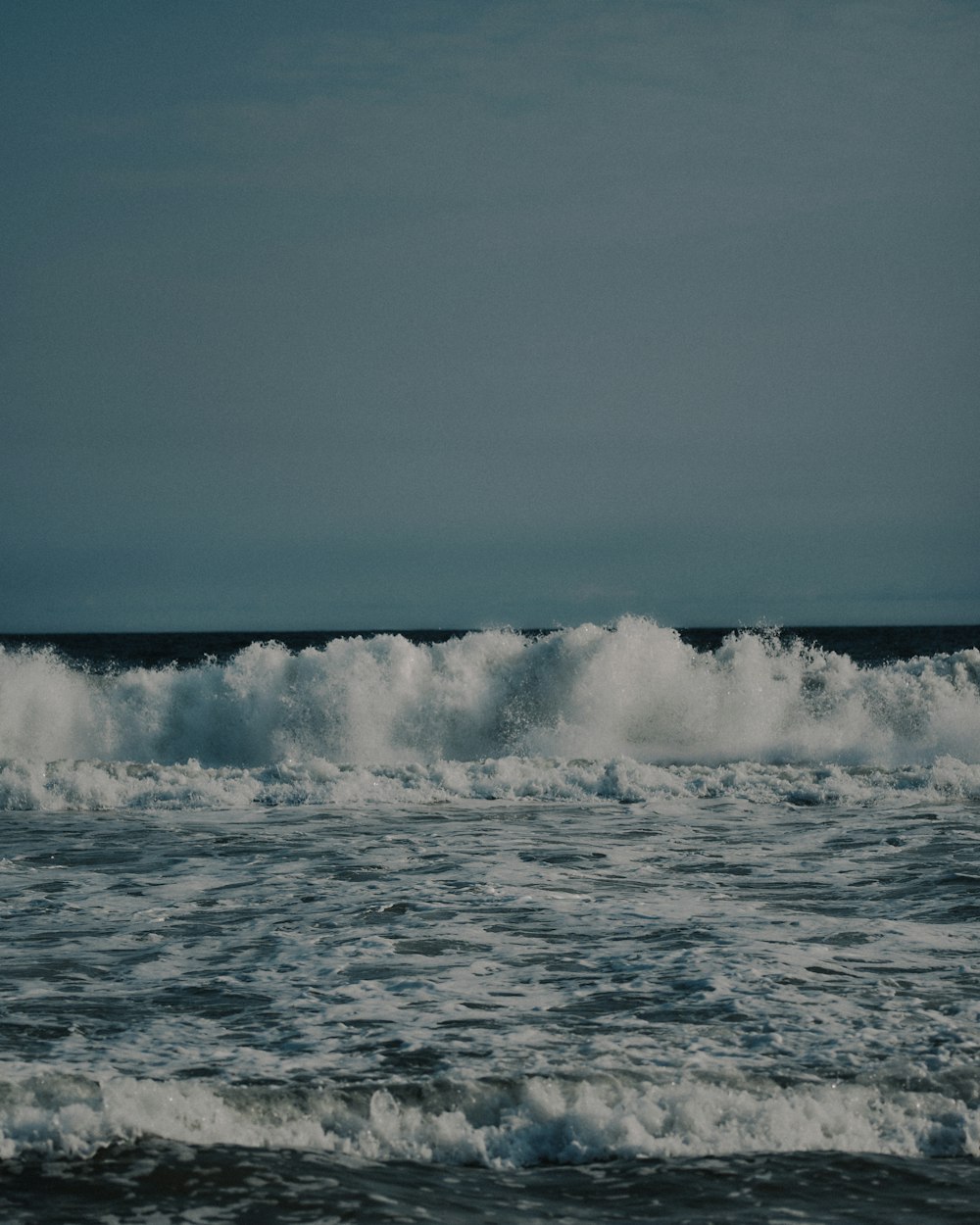 a person riding a surfboard on a wave in the ocean