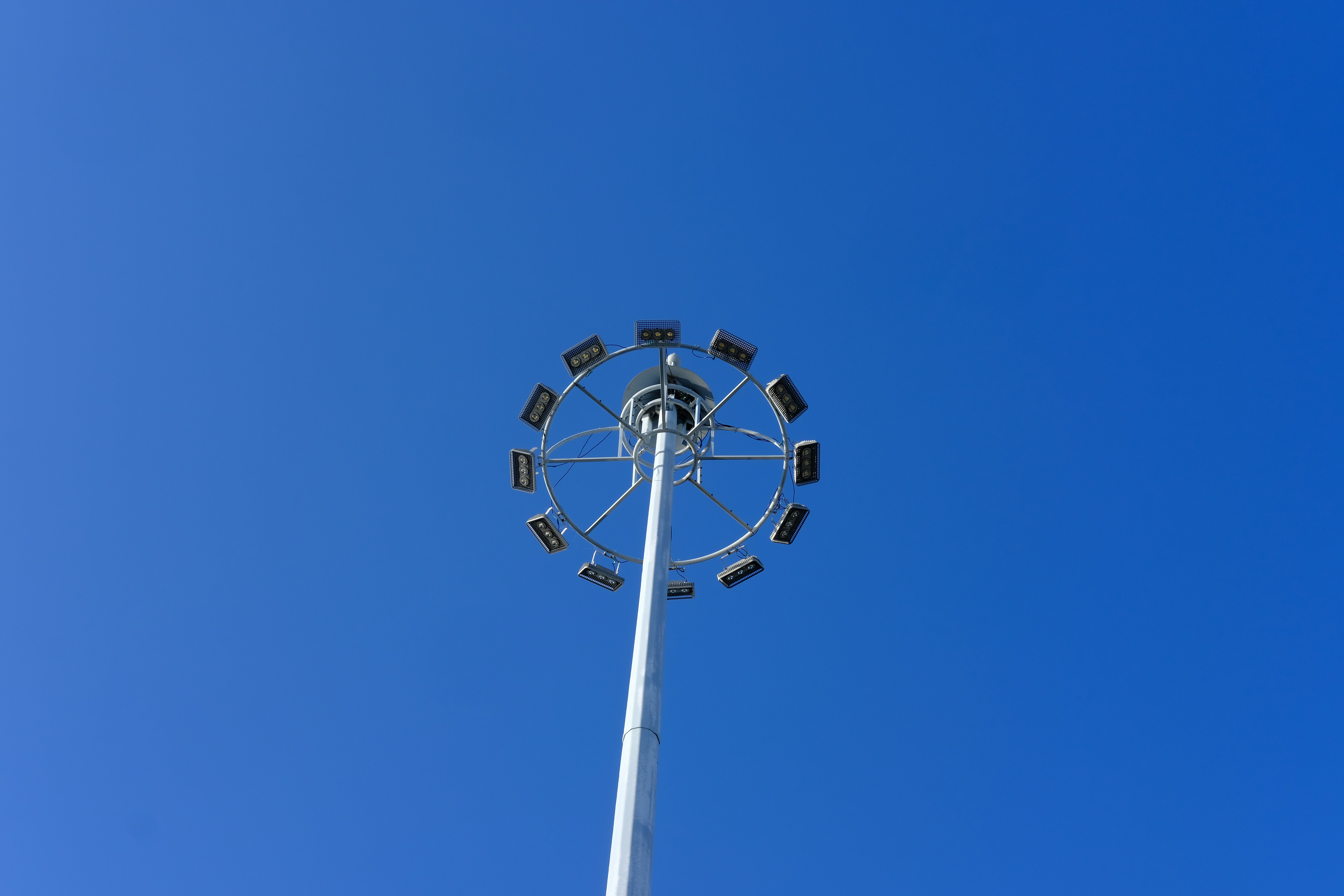 a tall white pole with a ferris wheel on top of it