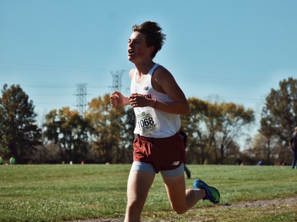 a man running in a race in a field