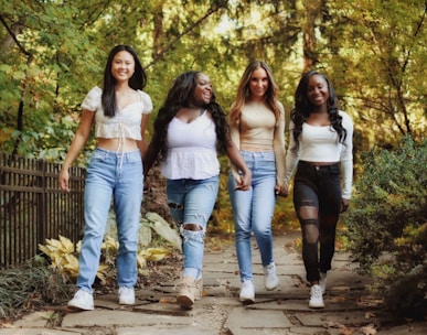 a group of young women walking down a path