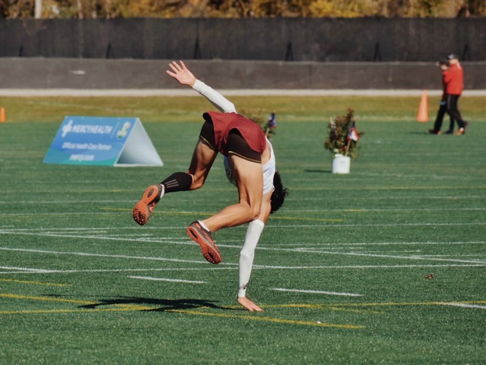 a person doing a handstand on a field