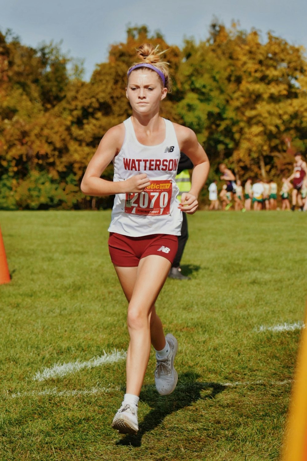 a woman running in a race on a field